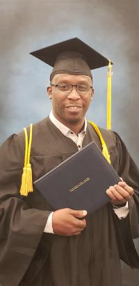 Trying it on for size: Gerard Placide in his cap and gown