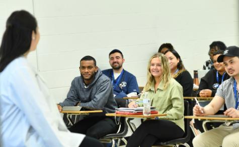 diverse group of students in class taught by a medical professional