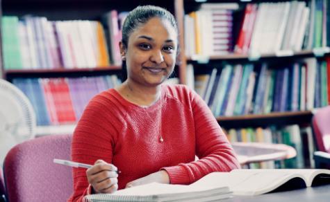 female student working in library