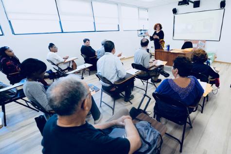 A group of NYSCAS tutors attends a meeting with Professor Inna Goldstein, Director of Learning Resource Centers in Brooklyn and Queens.